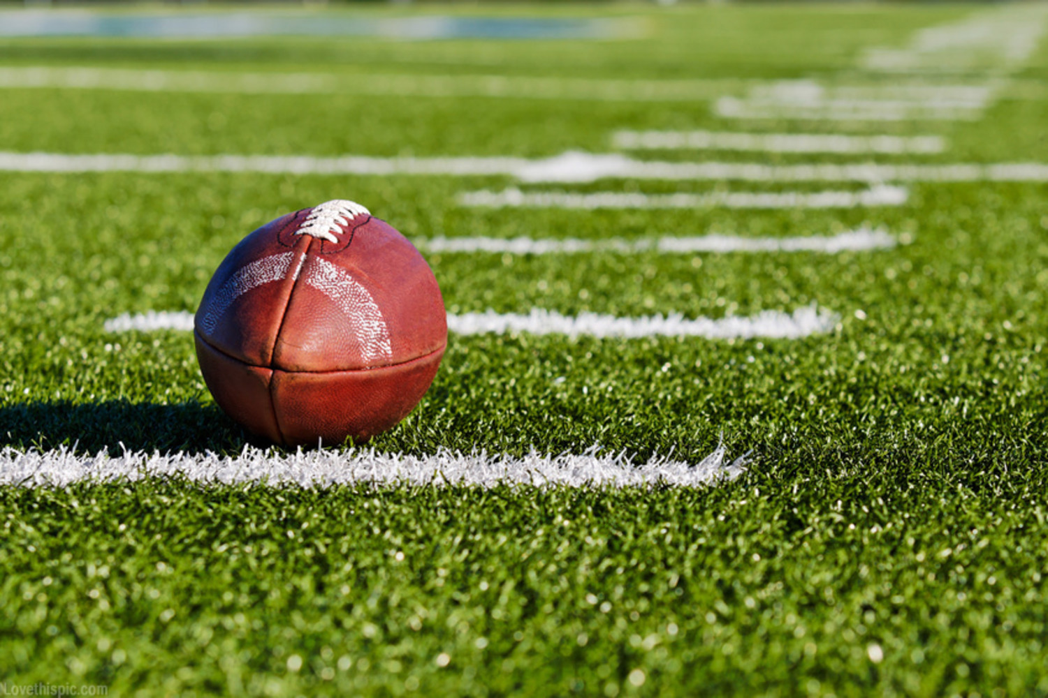 Football on Yardage Marker. Low Angle. Horizontial View